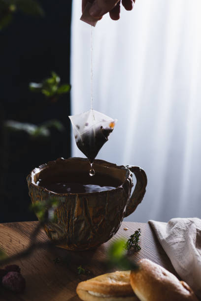 istock tea in a mug, dripping from a tea bag 2151053287