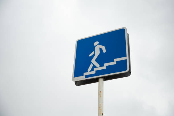 istock Walk down sign . Traffic sign pedestrian descending 2151054904