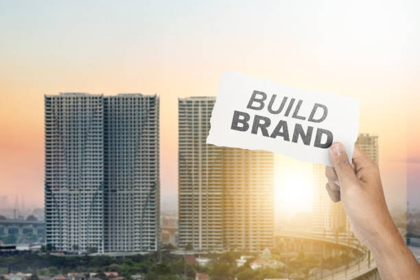 Human hand showing ripped paper with build brand text