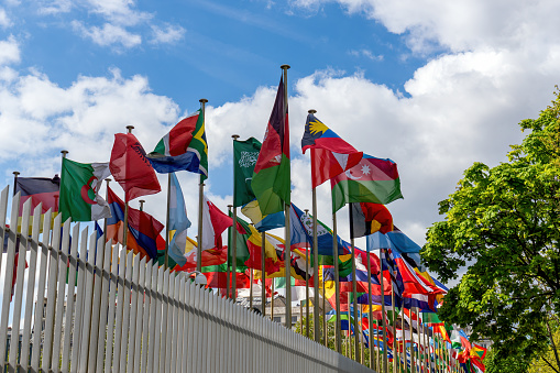 Paris, France - April 25 2024: Flags fluttering in the wind in front of the UNESCO (United Nations Educational, Scientific and Cultural Organization) headquarters at 7 place de Fontenoy in Paris.