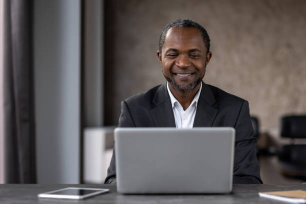 istock Professional African American man working happily on laptop 2151062515