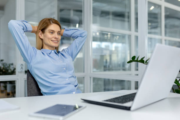 istock Relaxed businesswoman taking a break at her desk 2151063386