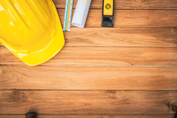 istock Top view desk of Engineer tools meticulously designs structures at desk, referring to blueprints for precision. Focuses on innovation, problem-solving, and attention to detail in engineering projects 2151063643