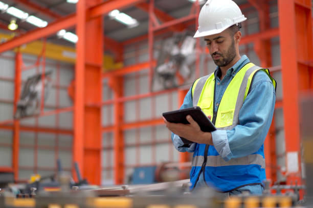 istock Engineer examining machines in factory. 2151066525