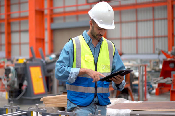 istock Engineer examining machines in factory. 2151066535