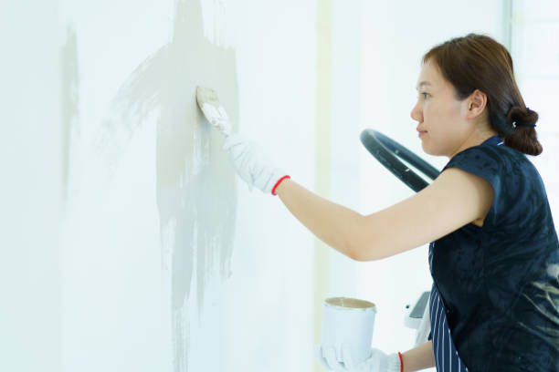 istock Woman painting the wall by herself. 2151066549