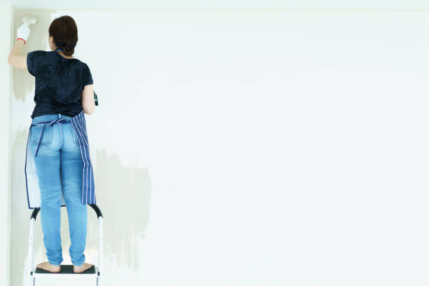 istock Woman painting the wall by herself. 2151066558