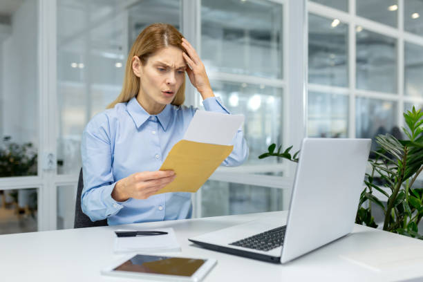 istock Businesswoman feeling confused with documents at office 2151066598
