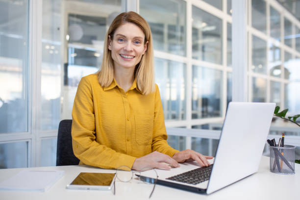 istock Empowered businesswoman working happily in office 2151066830