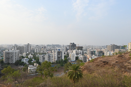 View of Pune in summer, Cityscape Skyline, buildings holdings, Signboards, and banners, Pune, Maharashtra, India - 30 April 2024