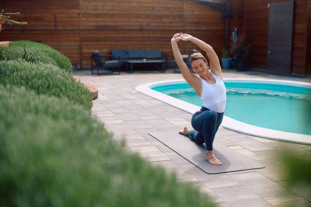 istock Smiling sportswoman doing stretching exercises while practicing Yoga outdoors. 2151068248