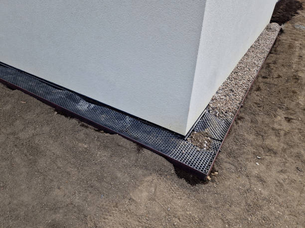 istock around house it is always necessary to create a gutter path made of gravel and pebbles. serves to absorb water and ventilate  walls of the house. installation of curb steel sheets. membrane foil, stud 2151069986
