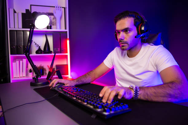 istock Serious face streamer concentrating gaming player trying to pass level. Surmise. 2151070374
