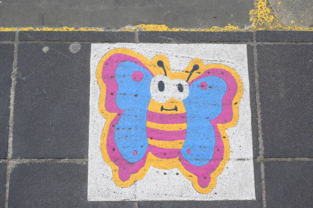 Echternach, Luxembourg - 04 27 2024: butterfly symbol at a crosswalk in old town, way symbol at the zebra crossing where kids should stand to be seen