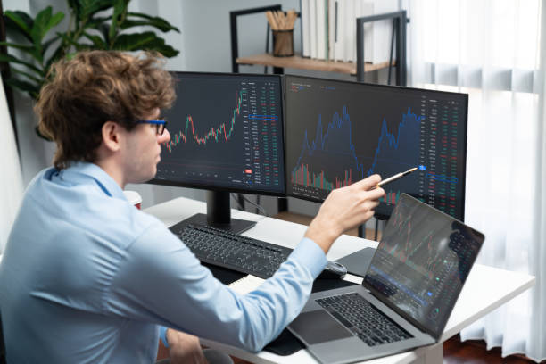 istock Working young business trader looking on laptop on laptop and pc. Gusher. 2151071548