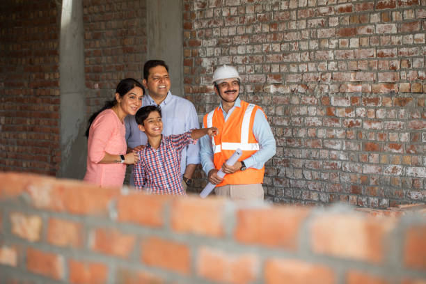 istock Architect showing new building to family at construction site 2151072104