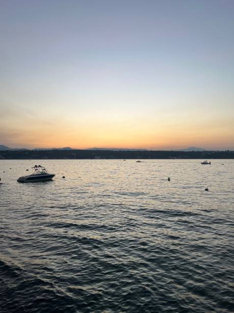 Sunset in Tequesquitengo lake in Morelos state in Mexico, boats, sky, parachute, diving.