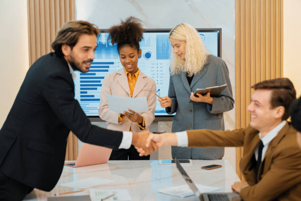 istock Successful businesspeople shaking hands while making agreement. Ornamented. 2151073302