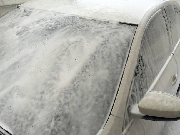 Washing car, soap sud on the car. Car washing in gas station