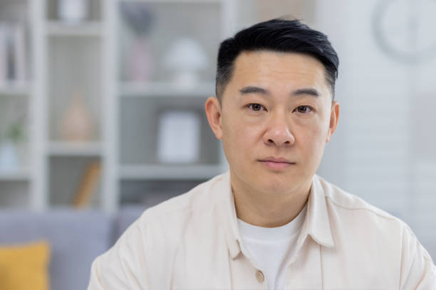istock Portrait of a middle-aged Asian man in a modern home setting 2151075356