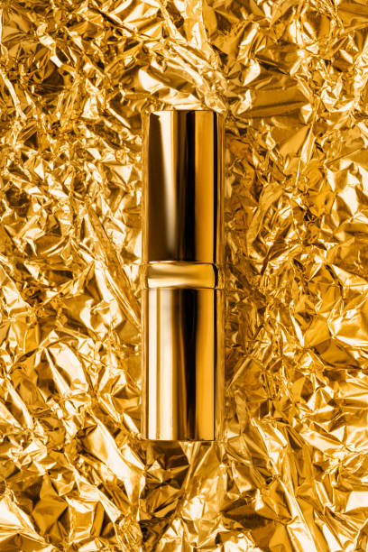istock Golden lipstick and foil 2151076844