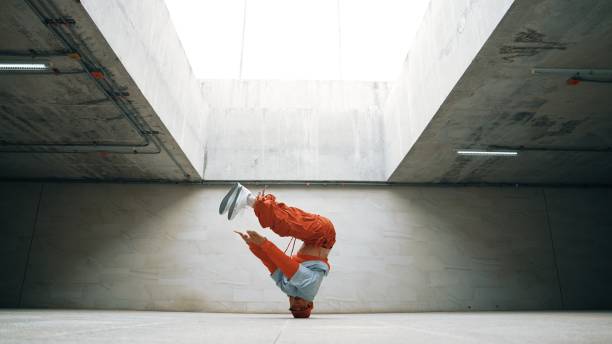 istock Dancing man enjoy practice break dance or freestyle in building. Sprightly. 2151077085