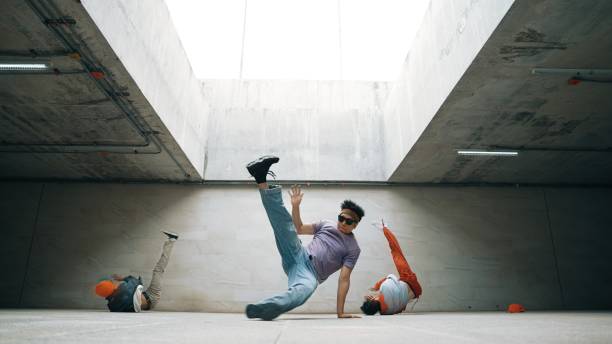 istock Group of stylish hipster group perform dancing together in building. Sprightly. 2151077191