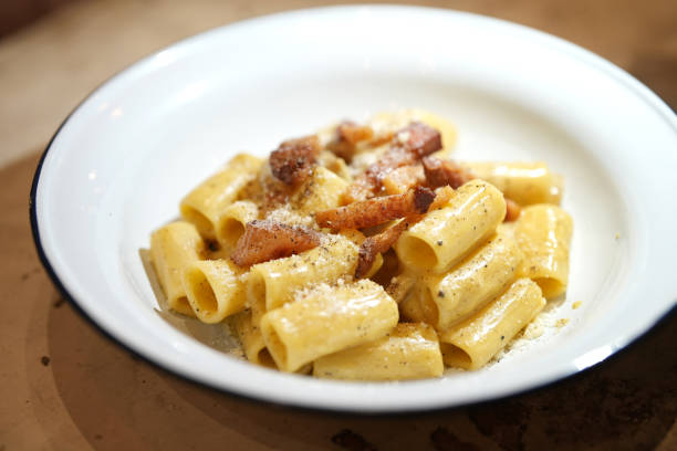 Creamy pasta rigatoni with pork guanciale and cheese
