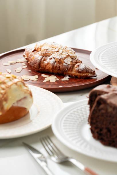 istock Homemade desserts sponge cake and cinnamon bun on table 2151077846
