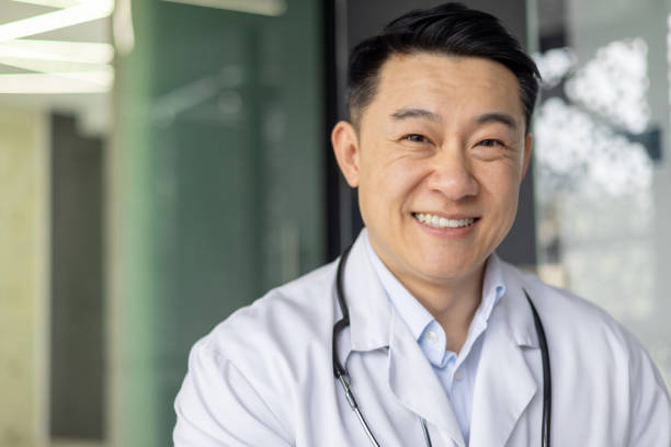 istock Confident Asian doctor smiling in a modern clinic setting 2151077977