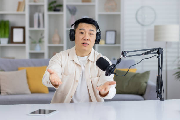 istock Asian man talking during a podcast recording session 2151078346