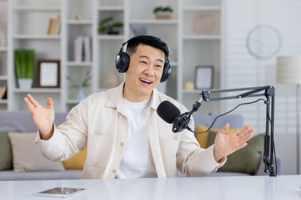 istock Asian man enjoying a lively podcast discussion indoors 2151078691