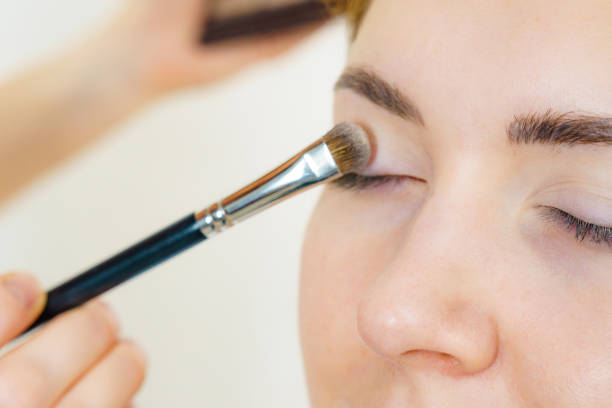istock Makeup artist applying eye make up 2151078950