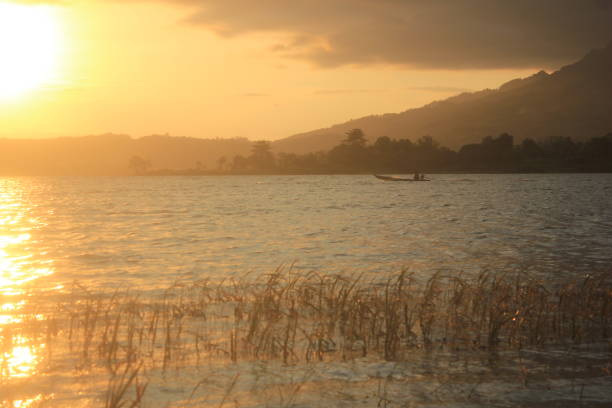 sunset moment at the lake. sun beam reflect to water surface. tranquil scene of sunset at the lake.  famous place in wonogiri, central java, Indonesia.