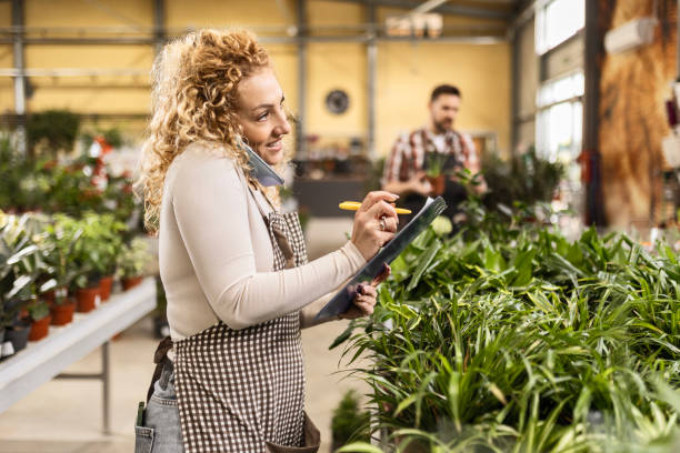 istock Florist Providing Phone Support in Plant Shop 2151079969