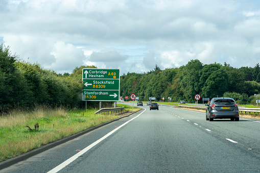 Corbridge, Northumberland, UK - August, 2023. Cars driving along the A69 near Corbridge through the beautiful Northumberland countryside.