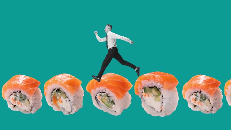 Stop motion. Animation. Young man running on sushi set isolated over blue background. Concept of Japanese food