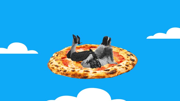 Stop motion. Animation. Woman and little girl lying on delicious pizza isolated over blue background. Retro style
