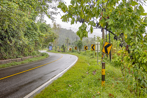 Wet and winding road road in lush surroundings. The picture is taken in Kecamatan Lubuk Sikaping in the northern part of Sumatra