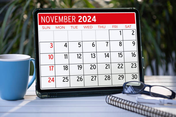A tablet computer with a 2024 calendar on the screen on the garden table.