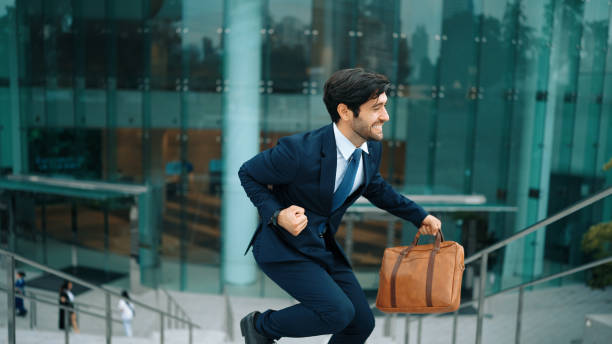istock Successful businessman celebrate for getting promotion while walking. Exultant. 2151082945