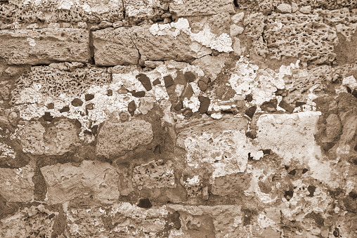 Sepia-Toned Texture Of Weathered Stone Wall