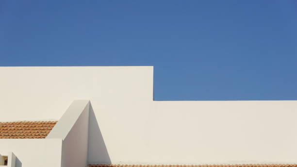 istock Minimalist White Mediterranean Building Against Blue Sky 2151084052