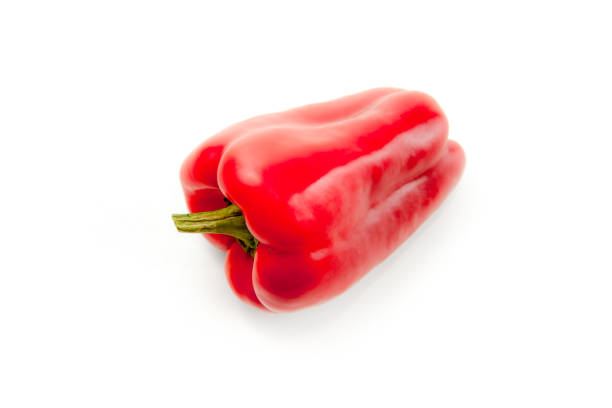 Whole red bell pepper (capsicum) known as sweet bell pepper, paprika isolated on white background with clipping path.
