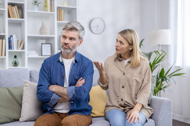 istock Mature couple discussing issues at home with serious expressions 2151084821