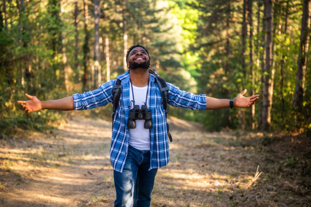 Hiker with arms raised enjoys in nature