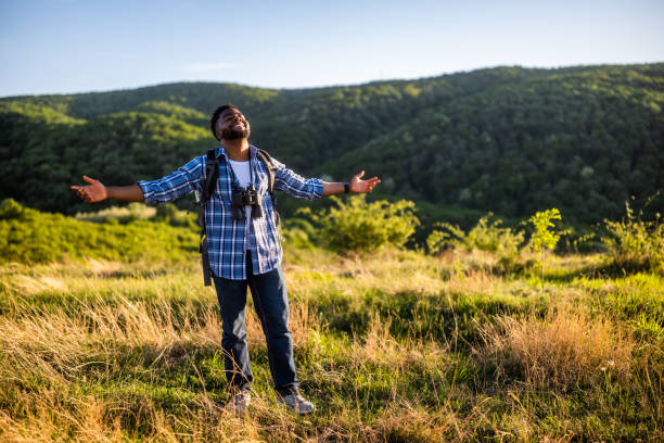 istock Hiker with arms raised enjoys in nature 2151085692