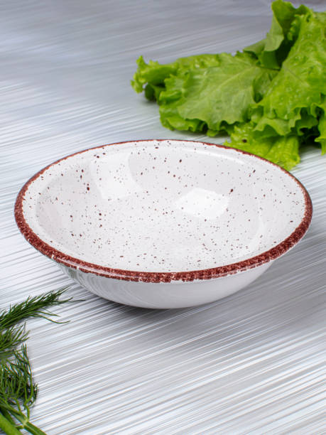istock Ceramic clay plate with dark edging on gray background 2151086057