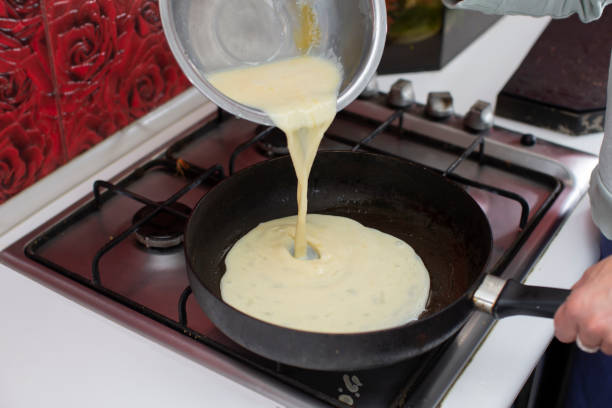 istock Pour the omelette mixture into the frying pan. Prepare breakfast. 2151086158