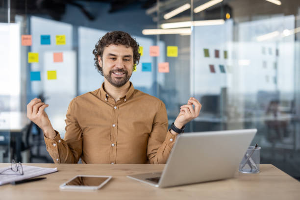 istock Cheerful businessman enjoying success at modern office 2151087791